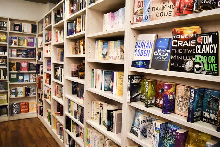 Interior of Book Trading, bookstore in Sofia, Bulgaria. Pale wooden bookshelves are filled with neatly stacked books.