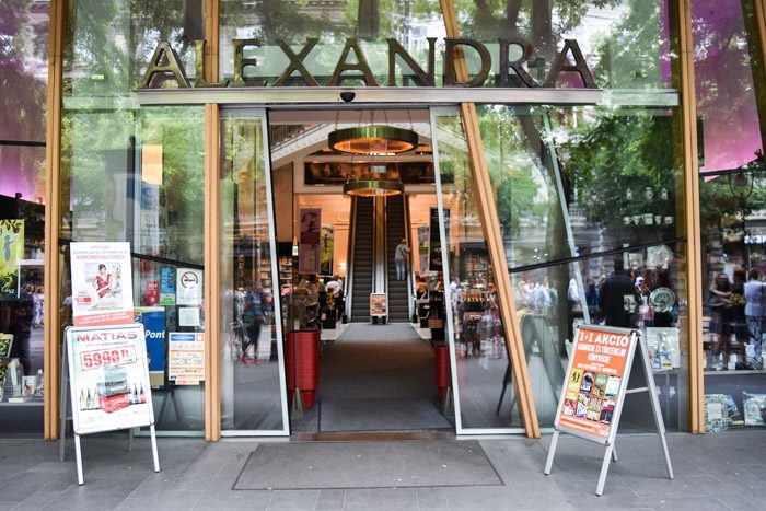 Picture of the front of Alexandra bookshop, with glass sliding doors opening up to a pair of escalators. 