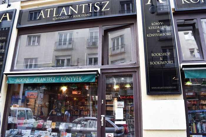 A picture of the front of this bookshop which displays the shop sign floor to ceiling windows providing a view inside the bookshop.