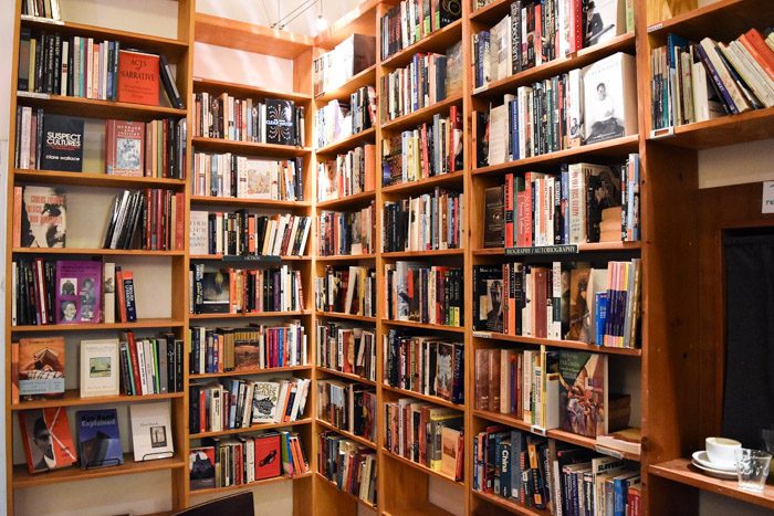 A corner space with wooden bookshelves and a range of secondhand books.