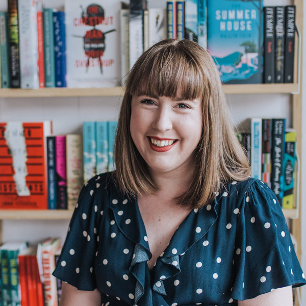 Tamsien West - Babbling Books, smiling at the camera, wearing a navy blue dress with white polka dots.