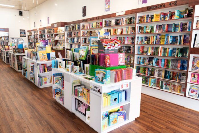 Picture of a long row of shelves and displays inside Warrnambool Books.