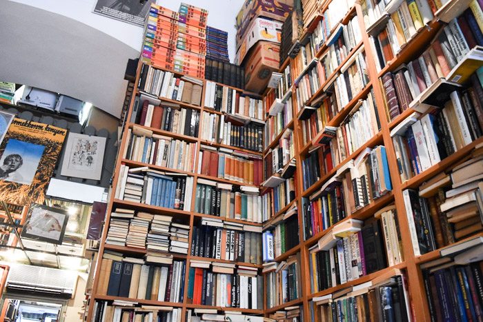 A bookshelf corner with books crammed into every possible space.