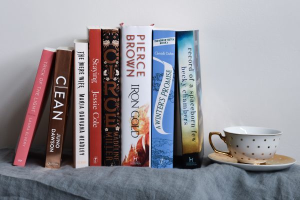 The books listed in the text below are stacked neatly next to a tea cup