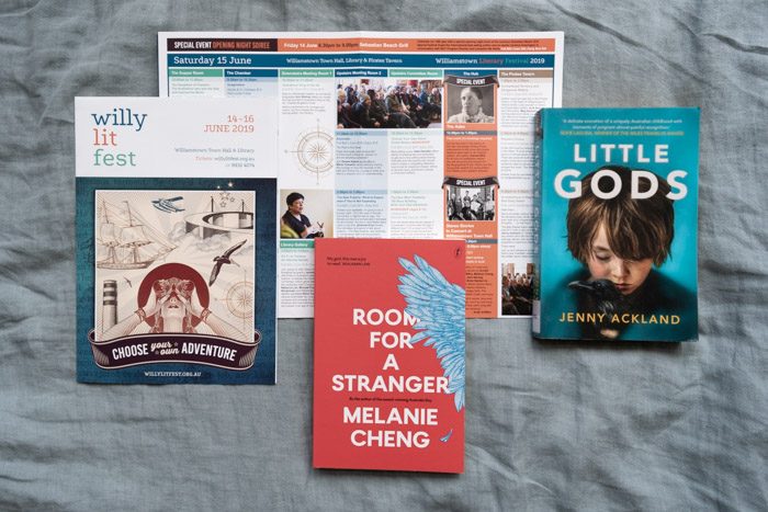 Willy Lit Fest: Top fiction picks, featuring Room for a Stranger by Melanie Cheng in the center and Little Gods by Jenny Ackland on the right, and the Willy Lit Fest program guide.