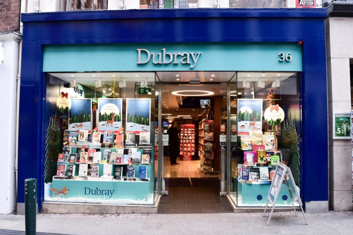 Dubray books shopfront with blue trim and windows opening into a bright-looking bookshop