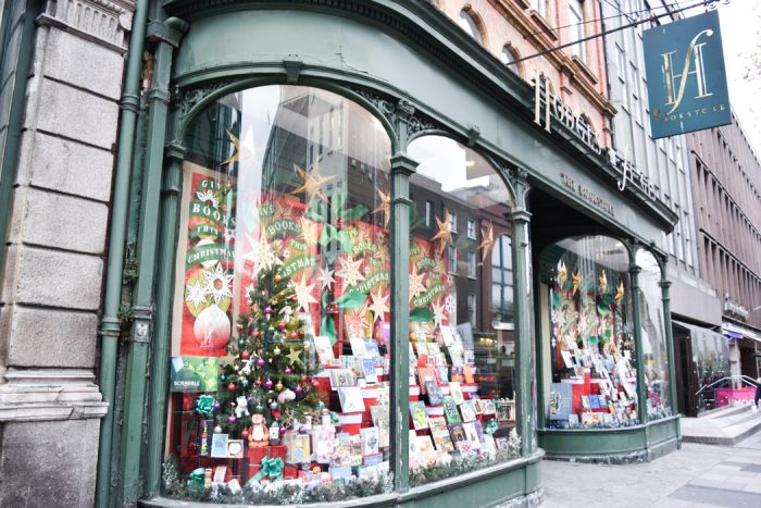 Prominent curved window display of the Hodges Figgis bookshop in Dublin with a Christmas theme.