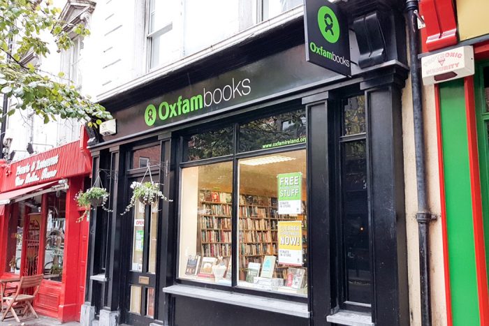 A black shopfront with the words Oxfam Books on the sign