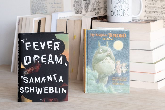 The book 'Fever Dream' next to the book 'My Neighbour Totoro'.