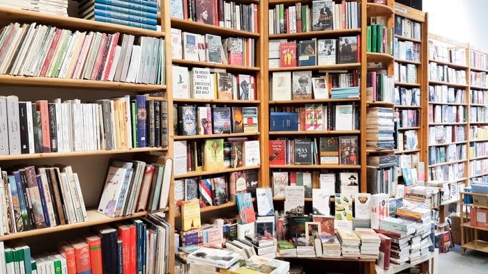 Interior of Sudseite bookshop with angled walls containing a large number of books for sale.