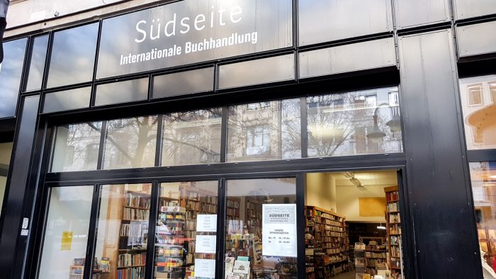 Front of Sudseite bookshop in Frankfurt, with a black exterior and window display visible.