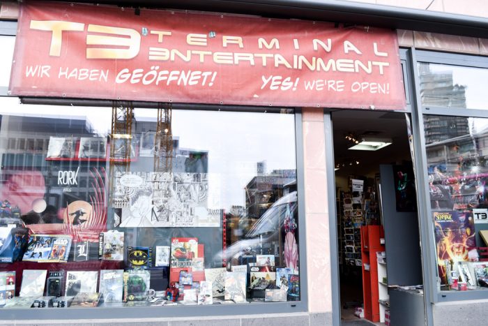 Front entrance to T3 Terminal Entertainment comic book shop with a window display containing a range of popular comics