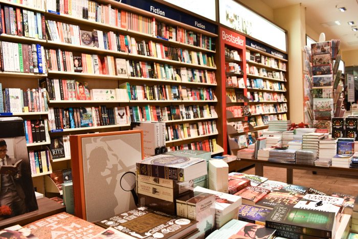 Wall full of books next to display tables