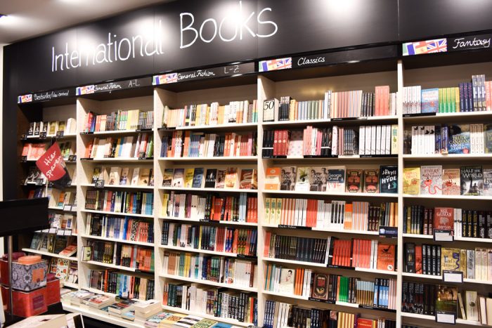 Wall of books for sale with a sign above it that says international books