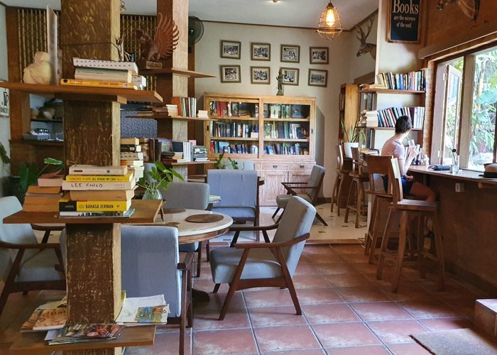 Interior of Ary's Book Cafe. Books are stacked on shelves all around the room. 