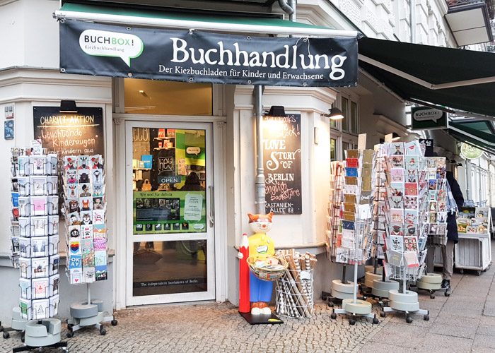 The front entrance to Buchbox, with several swiveling stands displaying gift cards for sale.