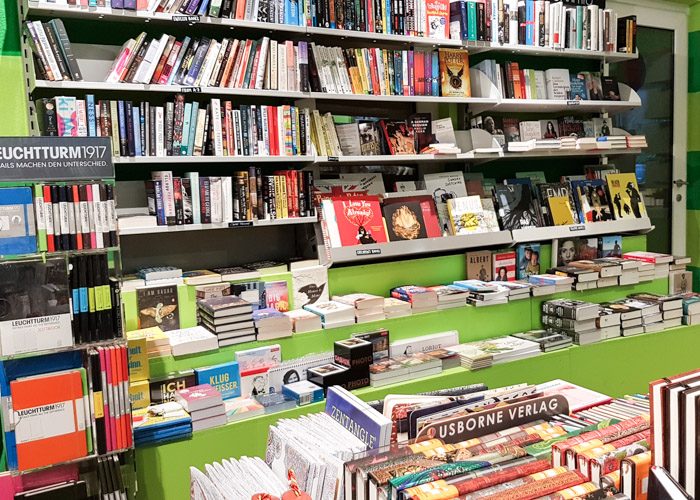 Green and grey bookshelves with a large range of German language books