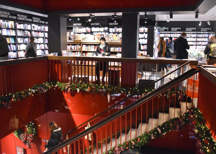 A red staircase adorned in Christmas decorations