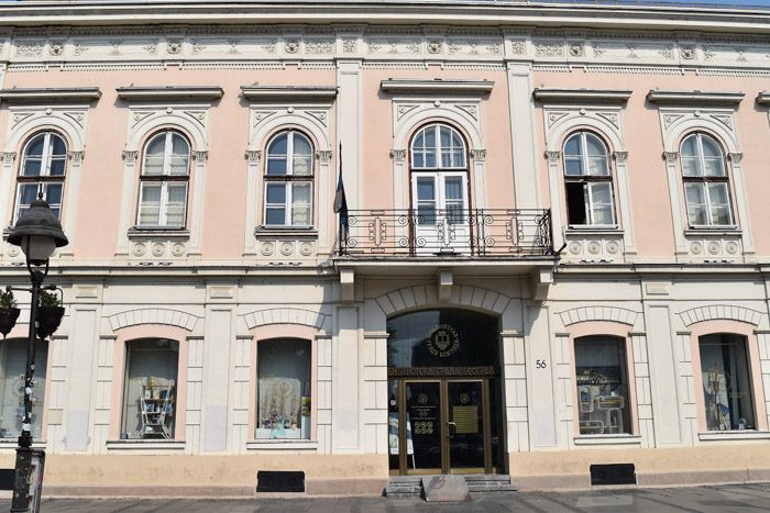 Exterior of Belgrade City Library. An imposing pink and white two story building. Book Lover's Guide to Belgrade, Serbia.