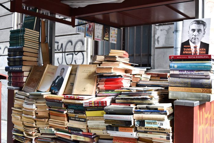 Book Cart Street, Ulica Hiljadutrista Kaplara, a cart is piled with old books. Book Lover's Guide to Belgrade, Serbia.