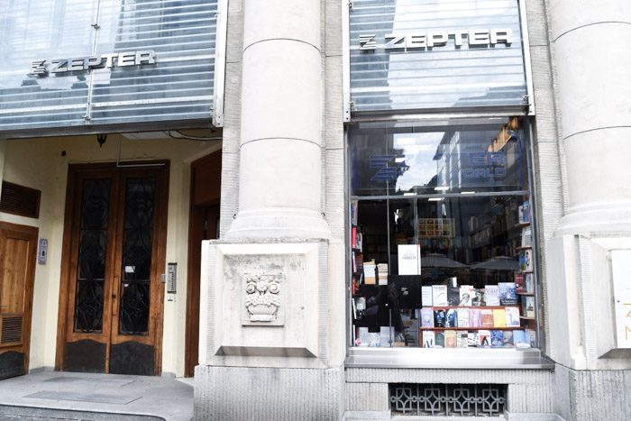 Exterior of Zepter Book World. Austere grey storefront has a small number of books displayed in the window. Book Lover's Guide to Belgrade, Serbia.