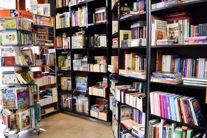 Interior of Zepter Book World. Black shelves are crowded with double stacked books. Book Lover's Guide to Belgrade, Serbia.